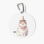 Round white pet tag on a metal clasp, printed with a watercolor fluffy gray and white cat in a party hat and a confetti bandana reading Pinkie.