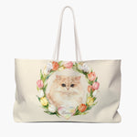 Cream weekender bag printed with a watercolor tulip wreath around a fluffy cream Persian cat, the pet's name in script on a pastel heart.