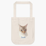 Natural cotton tote bag printed with a lifelike color portrait of a blue-eyed lynx point Siamese cat, with "Sushi" below in blue script.