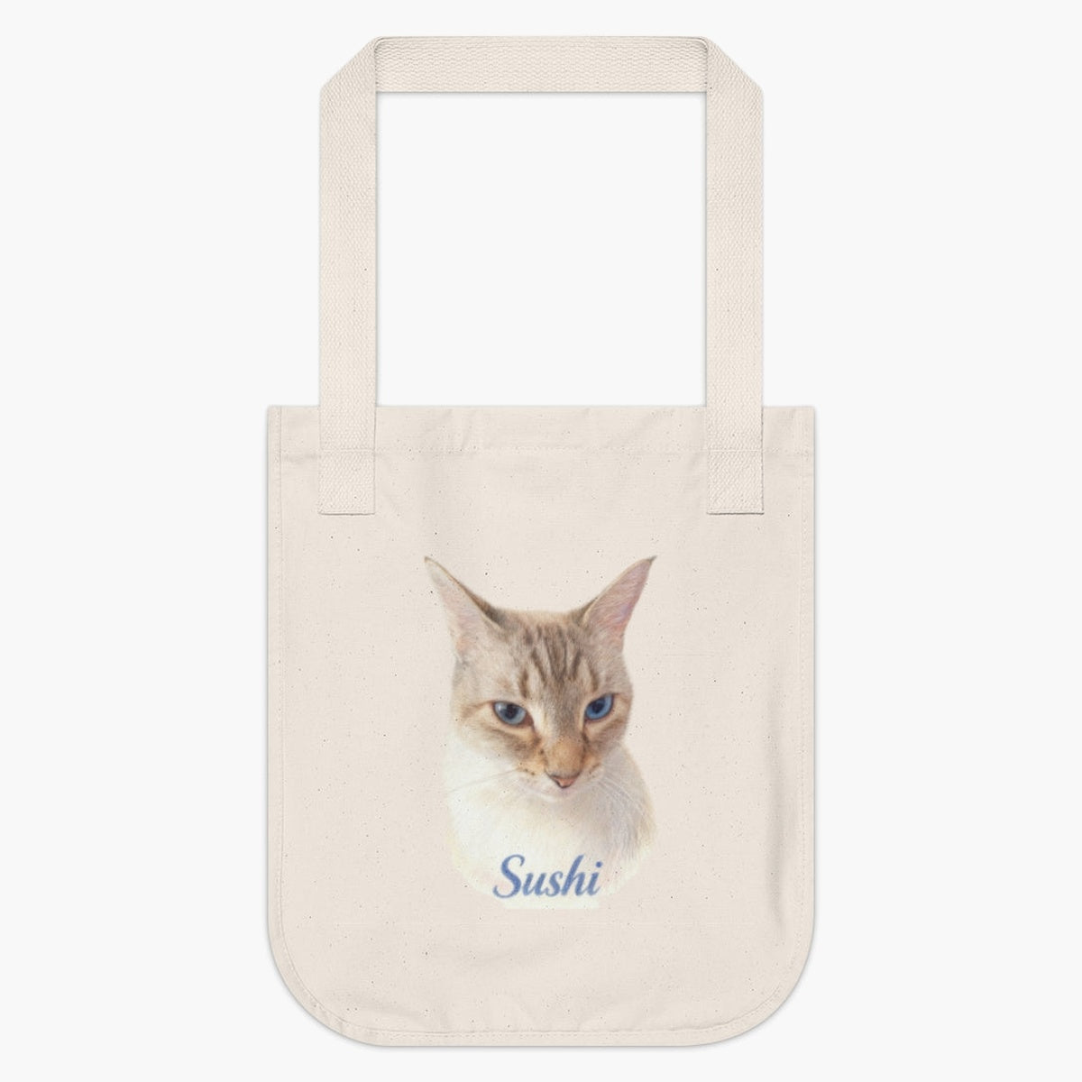 Natural cotton tote bag printed with a lifelike color portrait of a blue-eyed lynx point Siamese cat, with "Sushi" below in blue script.