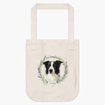 Natural cotton tote bag printed with a rosemary and lavender wreath around a black and white border collie, with "Sunshine" on a heart.