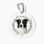 Round white pet tag on a metal clasp, printed with a watercolor border collie inside a rosemary and lavender wreath above a heart reading Sunshine.