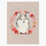 Beige fleece blanket printed with a blue-eyed Pomsky framed by a ring of watercolor roses and hearts, with the name "Mochi" below.
