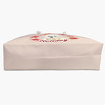 The blush rose-wreath weekender bag laid on its side, showing the flat base and wide gusset, with the design just over the top edge.