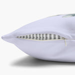 Close-up of the pale lilac pillow cover's edge with the concealed zipper open, showing the gray striped insert inside.