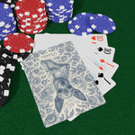 On a green felt table with red, blue and black chips, a fanned hand of tens and jacks sits beneath a card showing the blue Pebbles toile back.