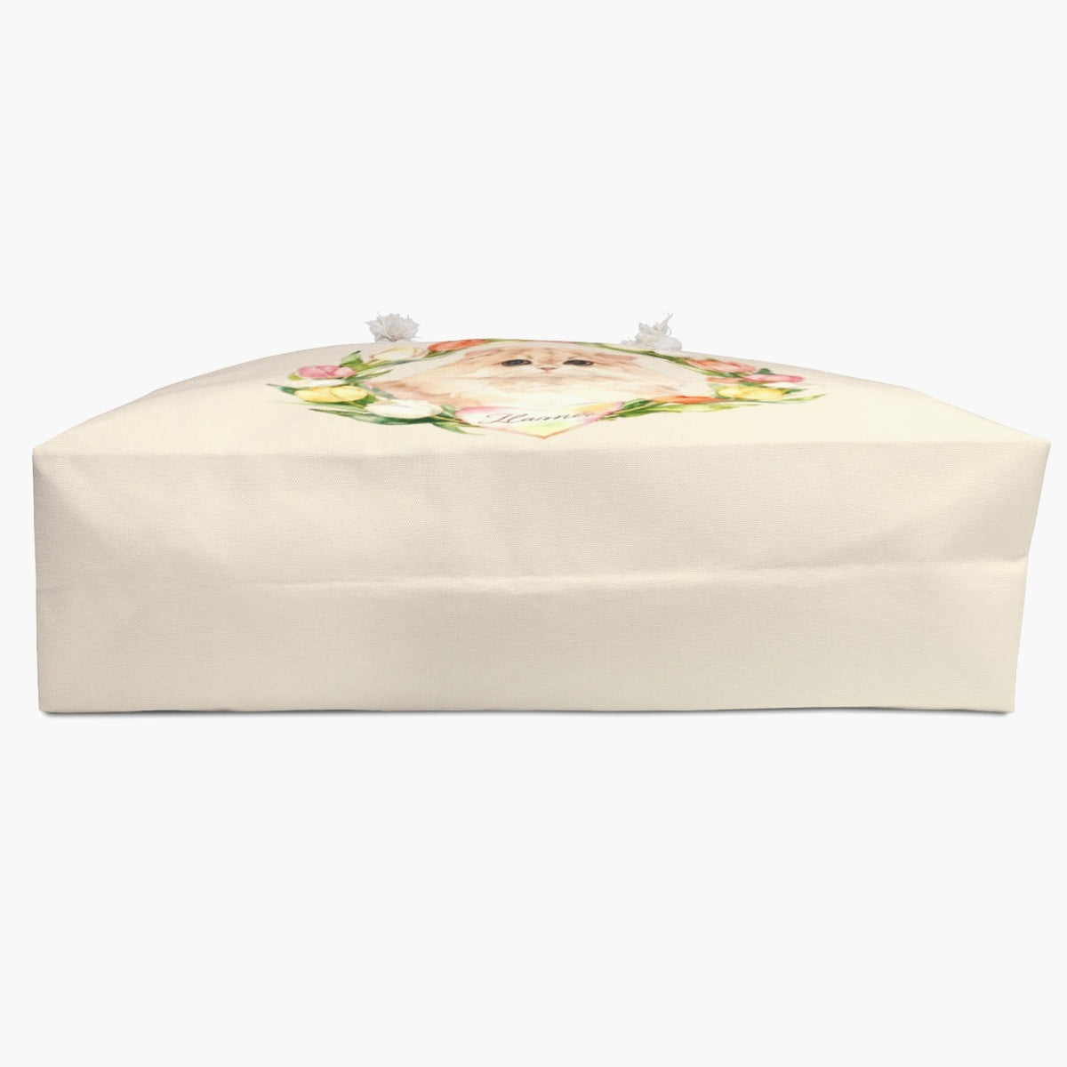 The cream tulip-wreath weekender bag laid on its side, showing the flat base and wide gusset, with the printed design just over the top edge.