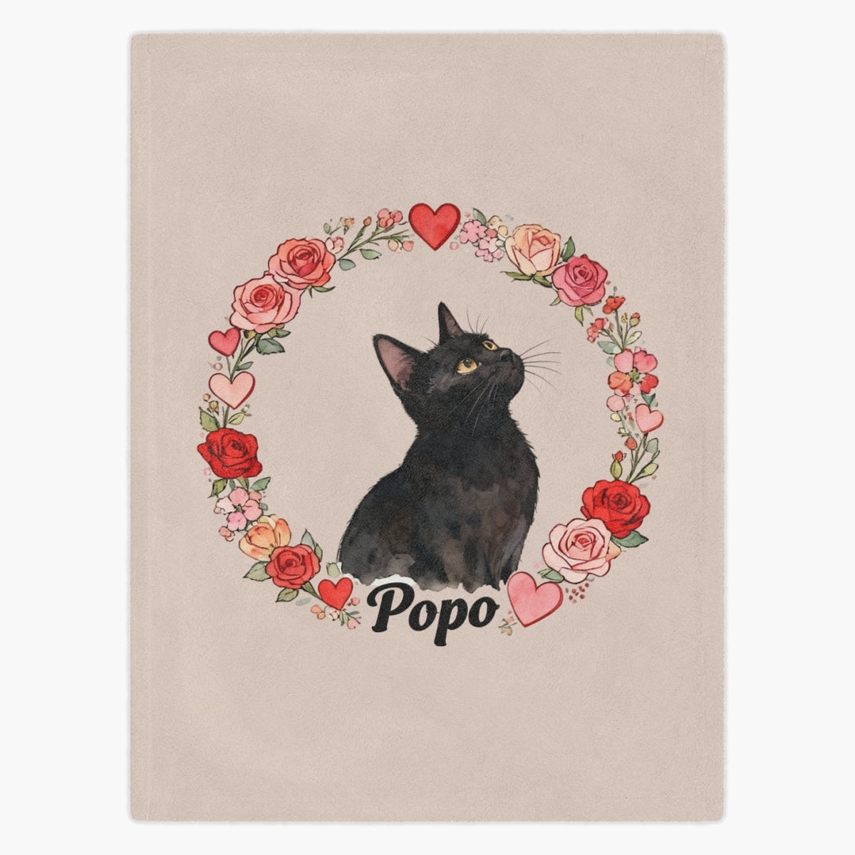 Beige fleece blanket printed with a black cat looking up, framed by a ring of watercolor roses and hearts, with the name "Popo" below.