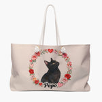Blush weekender bag printed with a wreath of roses and hearts around a black cat gazing upward, with "Popo" below in black script.