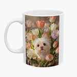 Oil-painting style print of a fluffy white dog nestled among pastel tulips and a cream peony, wrapped around a white mug.