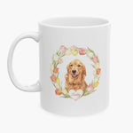 Watercolor portrait of a golden retriever in a pastel tulip wreath on the 11 oz white mug, with the name Reddy on a heart below.