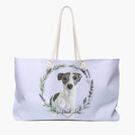 Pale lilac weekender bag printed with a rosemary and lavender wreath around a gray and white whippet, with "Dash" in script on a heart.