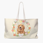 Cream weekender bag printed with a watercolor tulip wreath around a smiling golden retriever, with "Reddy" in script on a white heart.