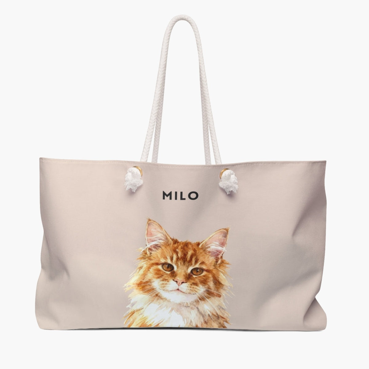 Watercolor portrait of a ginger long-haired cat on a dusty pink weekender bag with white rope handles, with the name MILO printed above.