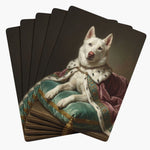 Five cards fanned face down, each back a painted portrait of a white husky in an ermine-trimmed pink robe reclining on a teal cushion.