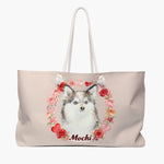 Blush weekender bag printed with a wreath of roses and hearts around a blue-eyed husky puppy, with "Mochi" below in dark red script.