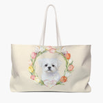 Cream weekender bag printed with a watercolor tulip wreath around a small white Maltese, the pet's name in script on a pink heart.