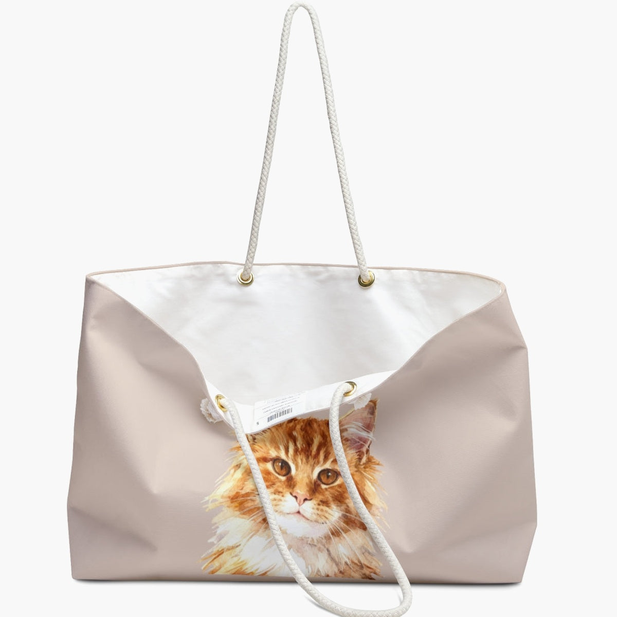 The dusty pink weekender bag standing open, white cotton lining and care label visible, with the watercolor ginger cat portrait below.
