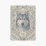 A single card back engraved in blue on cream with a husky's head surrounded by roses and leafy vines, with the name Fly below.