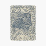 A single card back showing a blue toile engraving of a tabby cat lying among roses, a courting couple behind, and the name Toby Beans below.