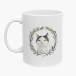 Watercolor portrait of a black and white cat inside a rosemary and lavender wreath on a white mug, with the name Chester on a heart below.