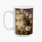 Oil-painting style print of a brown tabby cat among pastel tulips, wrapped around the larger white mug.