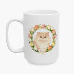Watercolor portrait of the cream Persian cat in a pastel tulip wreath, printed on the taller 15 oz white mug and seen from the front.