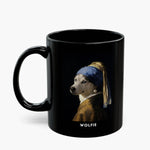 A husky painted into Vermeer's "Girl with a Pearl Earring", in a blue and gold turban with a pearl drop, on an all-black 11 oz mug, name "WOLFIE" below.