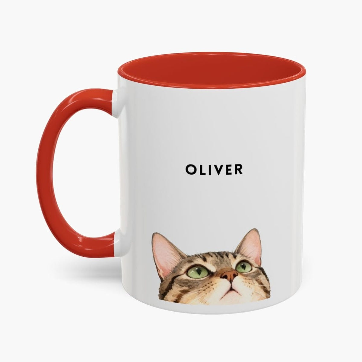 Watercolor tabby cat peeking up over the bottom edge of a white 11 oz mug with a red handle and inner glaze, name "OLIVER" above.