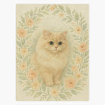 Cream fleece blanket printed with a fluffy cream long-haired cat inside an oval wreath of peach roses and sage green leaves.