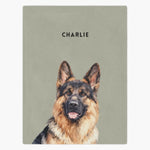 Watercolor portrait of a German shepherd printed on a sage green fleece blanket, with the name "CHARLIE" in capitals above.