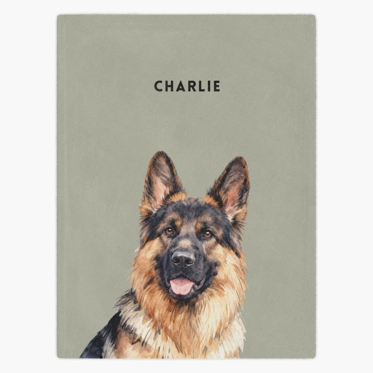 Watercolor portrait of a German shepherd printed on a sage green fleece blanket, with the name "CHARLIE" in capitals above.