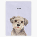 Watercolor portrait of a scruffy gray and cream terrier printed on a lavender fleece blanket, with the name "JOJO" in capitals above.