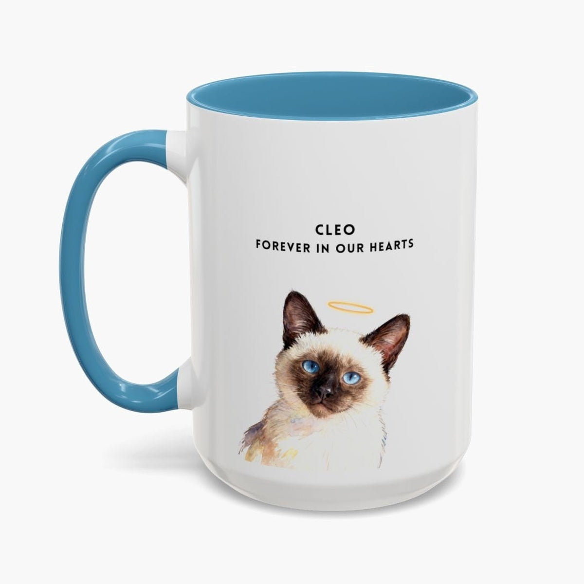 Watercolor Siamese cat wearing a gold halo on a taller white 15 oz mug with a light blue handle, lettered "CLEO" and "FOREVER IN OUR HEARTS".